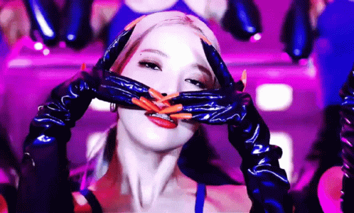 a woman in latex clothes has her hands wrapped around her head