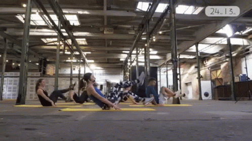 several people doing yoga in an indoor space