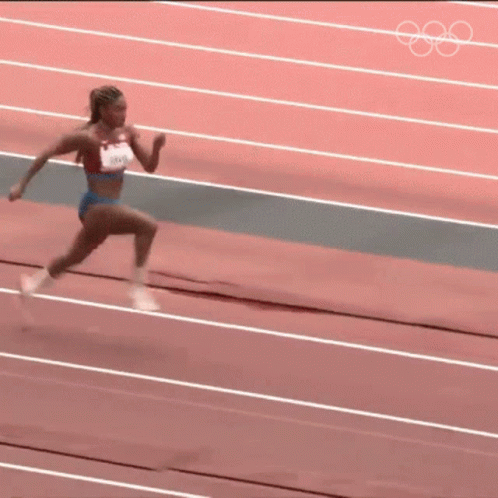 an olympic competitor with grey and yellow clothes is running