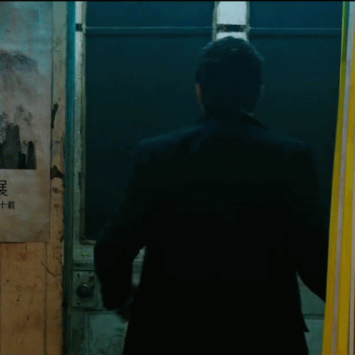 a man stands in front of a door