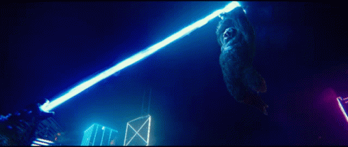 a large bear standing on top of a wooden pole in the dark