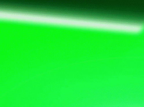 a green sheet of paper next to a wall