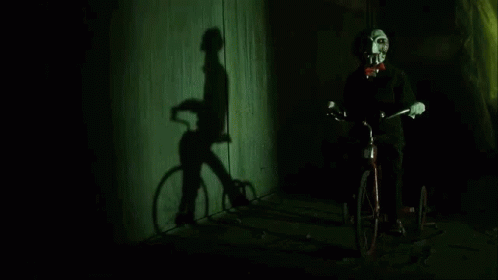 a shadow of a person standing next to a bike