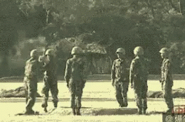 a group of soldiers walk together in a line