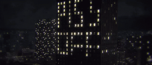 a tall building with glowing lights around the buildings