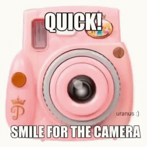 a camera that is sitting next to the caption that reads, quick smile for the camera