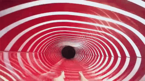 a man who is sitting inside of a very unique looking tunnel