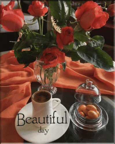 an arrangement of flowers and tea on a table