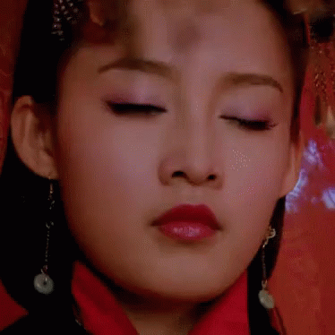 an asian woman with closed eyes and eyes closed