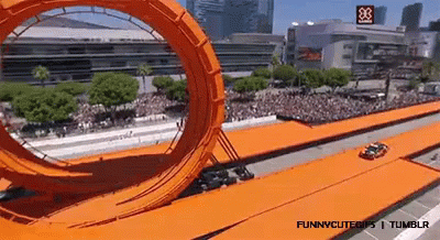 a roller coaster in front of a crowd of people