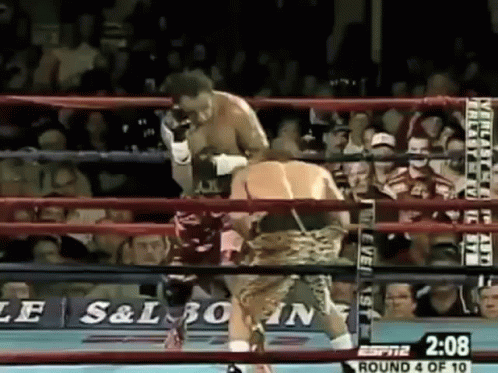 a professional boxers hits the referee's head at an opponent