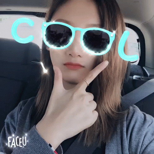 a woman wearing bright glasses that says cool