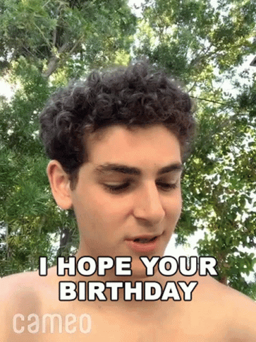 the man is looking at the camera with the birthday message above him
