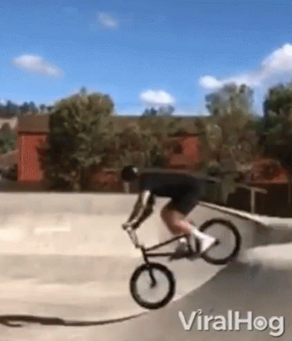 a man on a bike is being pulled by a skateboard