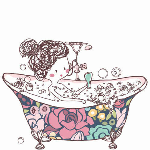 a woman is sitting in a bathtub with flowers and bubbles on the side