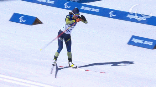 the olympic athlete is racing her skis around the course