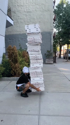a man leaning on a tall stack of papers