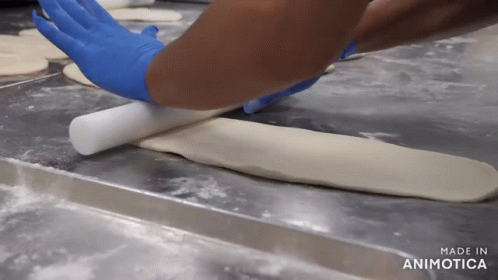 a person that is making a pizza with paper towels