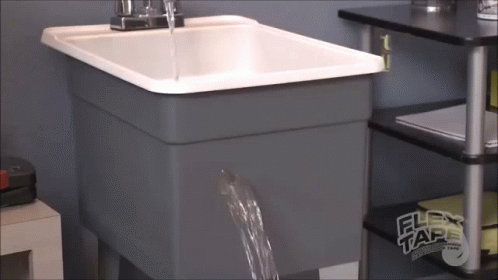 the sink has been built into the wall with the water coming out of it