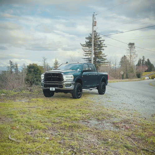 a large dodge ram truck is parked on the side of a road