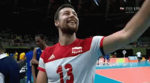 a person on a court with his hands raised up