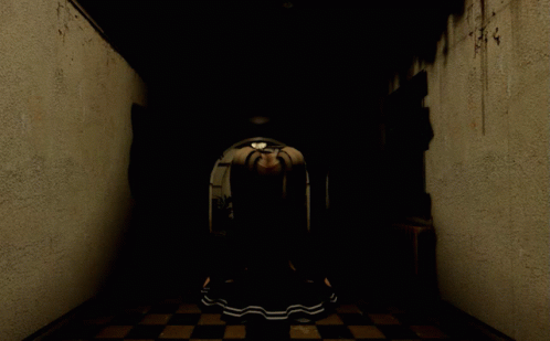 a dark hallway that has a round object at the end