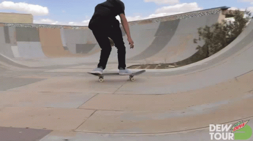 a boy in black shirt riding a skateboard on ramp