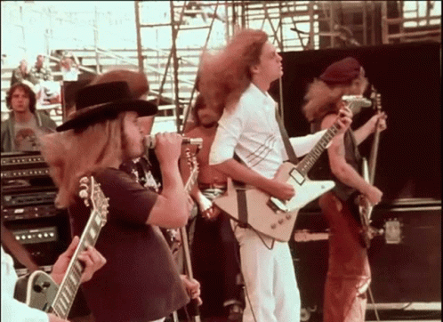 a group of people standing and playing guitars