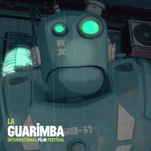 a large robot sitting under a green light
