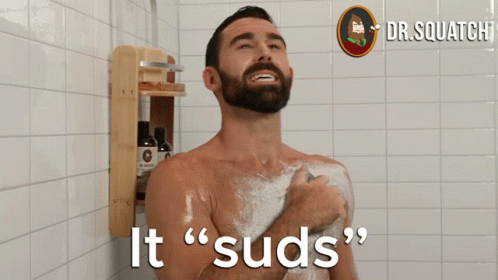 a man in the shower with a lot of hair and beard