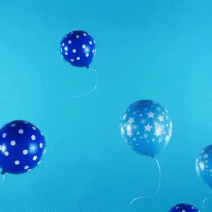 balloons floating from a yellow background on the ground