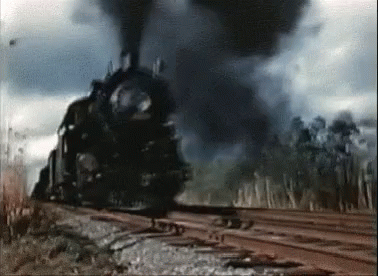 an old steam engine pulling cars with smoke pouring out