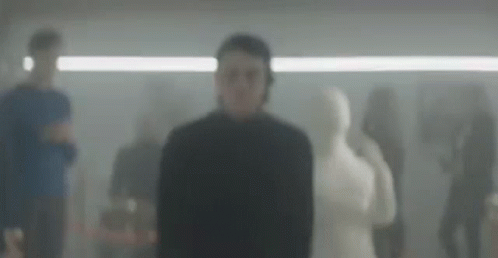 blurry image of men in a room with mannequins