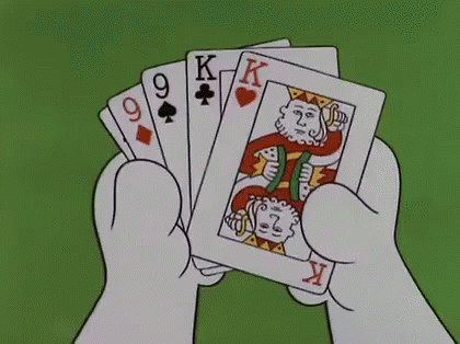 an image of a man's hand holding a deck of playing cards
