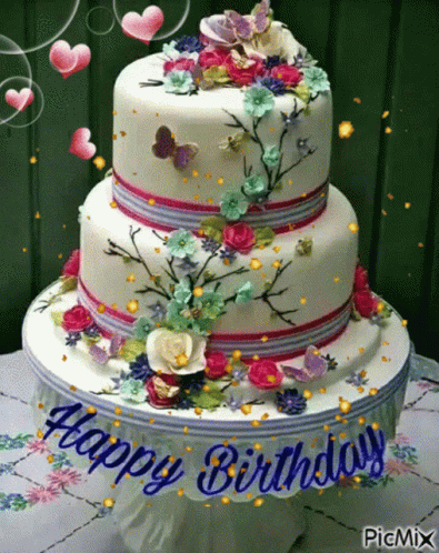 a birthday cake with colorful flowers and purple erflies on it