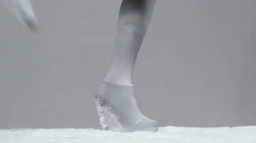 there is a foot standing on top of snow