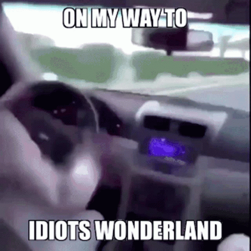 a person driving with a red dot on the dashboard
