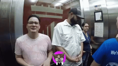 people standing in a bathroom stall on the elevator