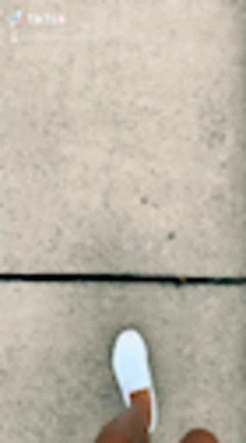 the feet and shoe are standing in a tile floor