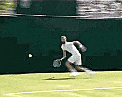 the man is playing tennis on the court