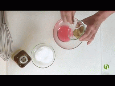 hand squeezing blue liquid into a cup