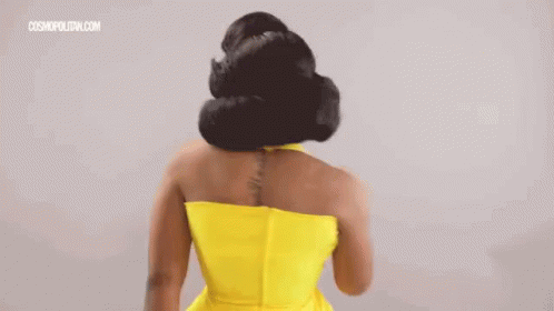 a woman's hair is flowing down into the back of her dress