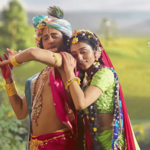 a couple dressed up in colorful garbana dancing with words written below them