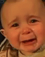 a baby is laughing in the middle of a blue screen