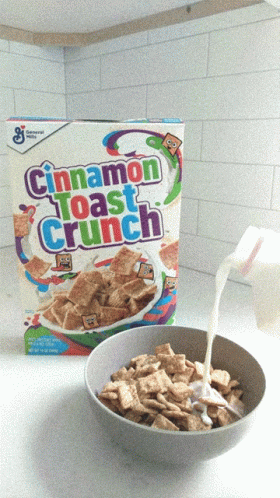 bowl of cereal and carton of blue curd next to it