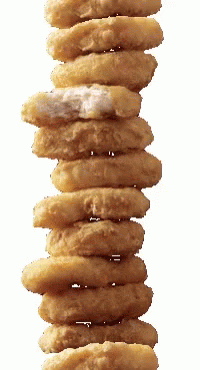 a tall stack of doughnuts hanging up against the sky