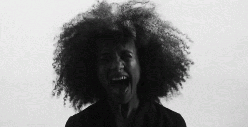 a woman with curly hair shouting