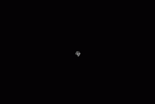 a small white object in the middle of the night sky