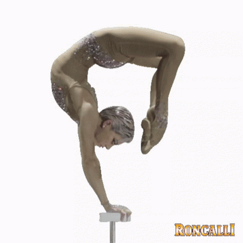 a man performs gymnastics on a balance beam