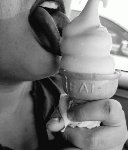 black and white pograph of girl eating ice cream cone